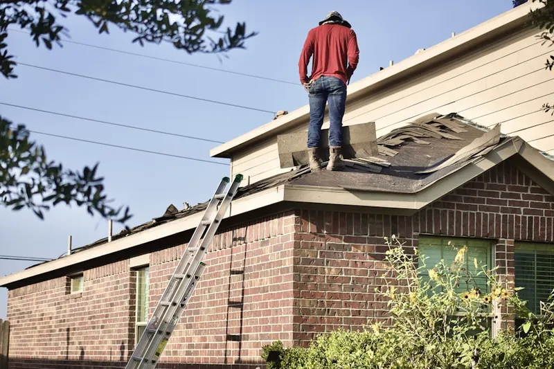 Professional roofer working on a residential roof in Busenbark